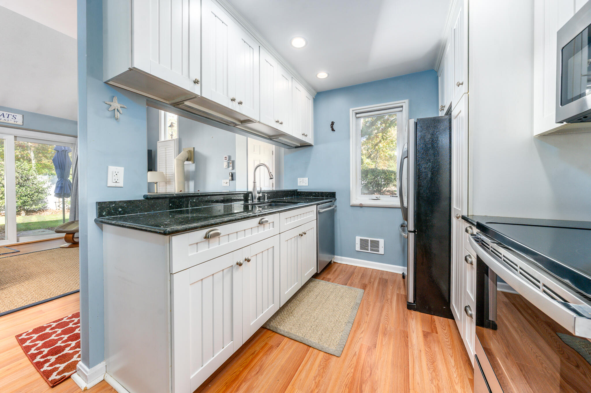 104 Howland Circle, Unit 104 Brewster, MA 02631 - Photo 7 of 29 a kitchen with stainless steel appliances granite countertop a sink and cabinets