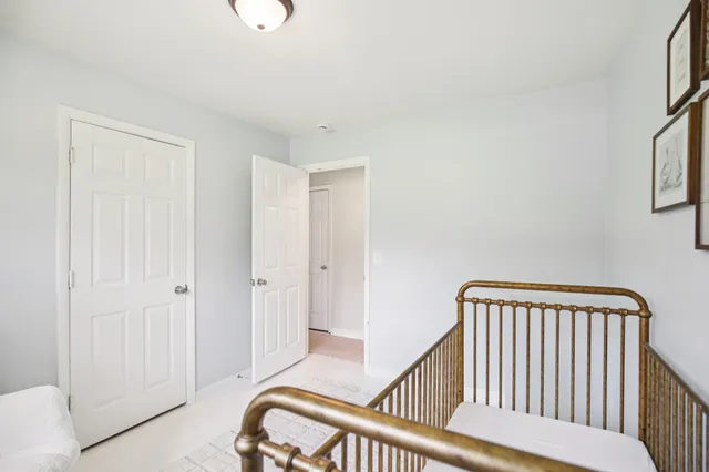 a bedroom with a bed and a view of bathroom