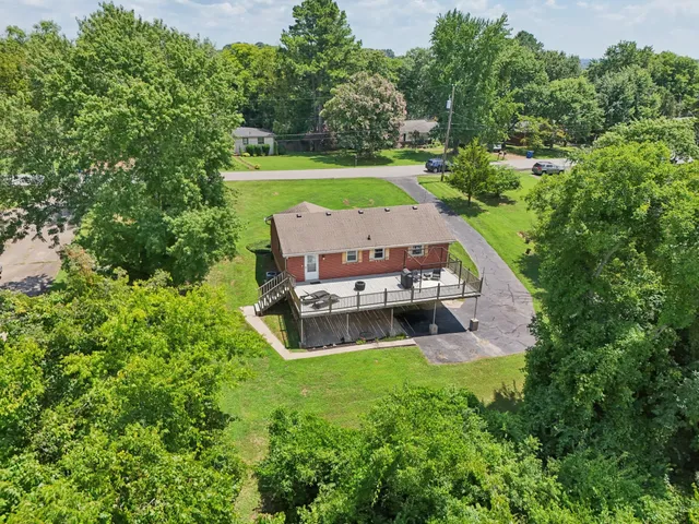 a front view of a house with a garden and yard