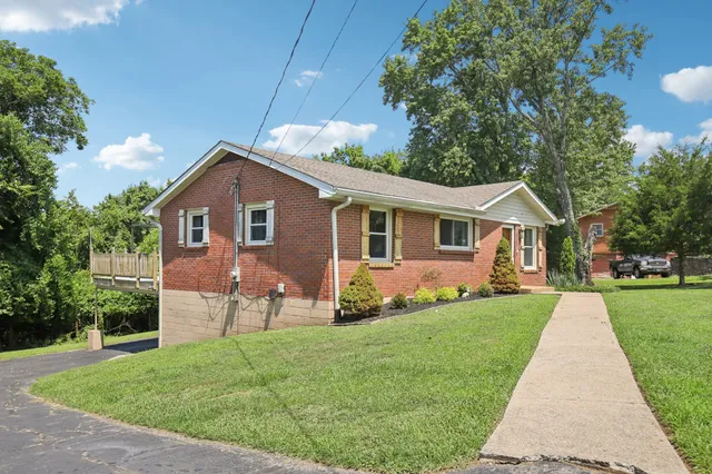 an aerial view of a house with swimming pool outdoor seating and yard