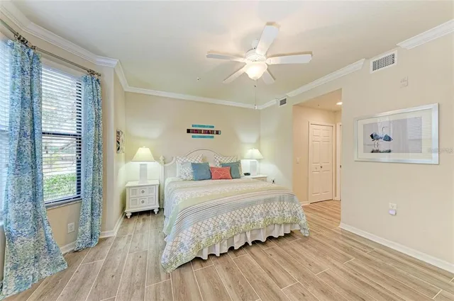 a bedroom with a bed and wooden floor