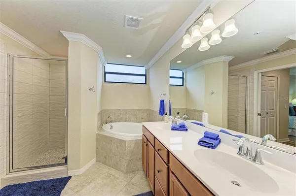 a bathroom with a sink a large mirror and a shower