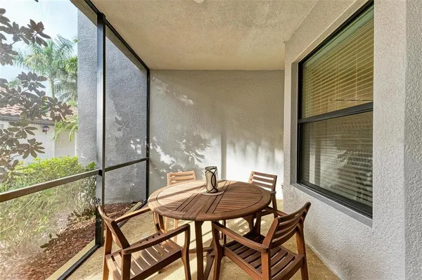 a backyard of a house with table and chairs