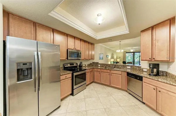 a kitchen with granite countertop stainless steel appliances and sink