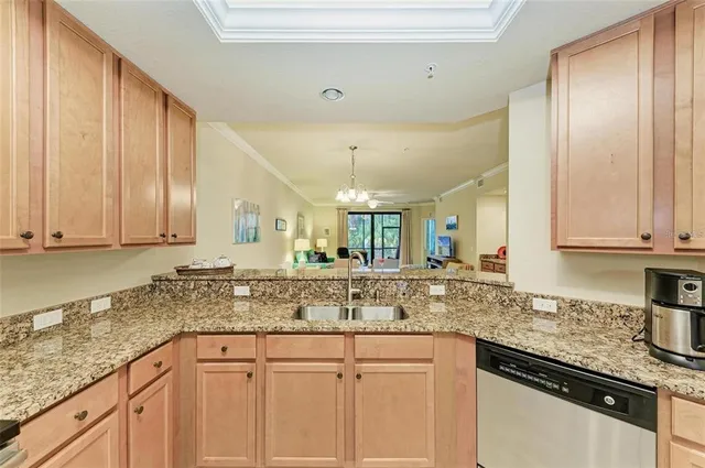 a kitchen with granite countertop stainless steel appliances sink stove and cabinets