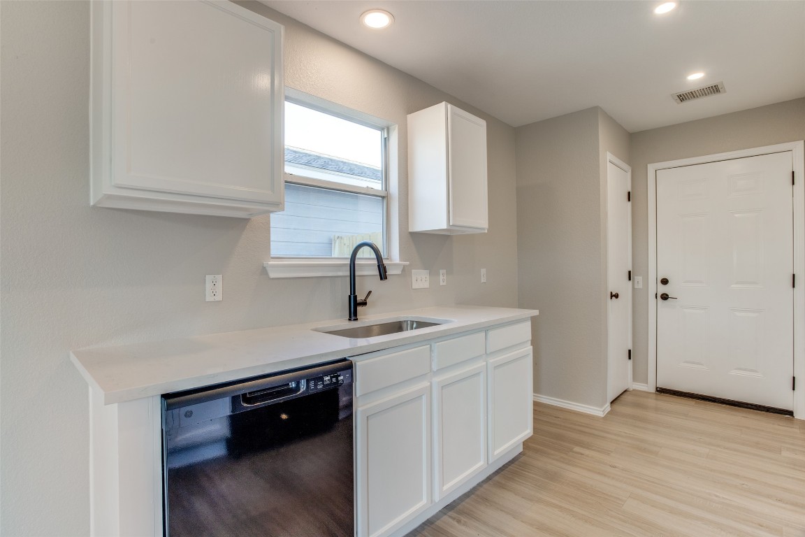 13145 Briarcreek Loop Manor, TX 78653 - Photo 11 of 25 a kitchen with a sink cabinets and wooden floor