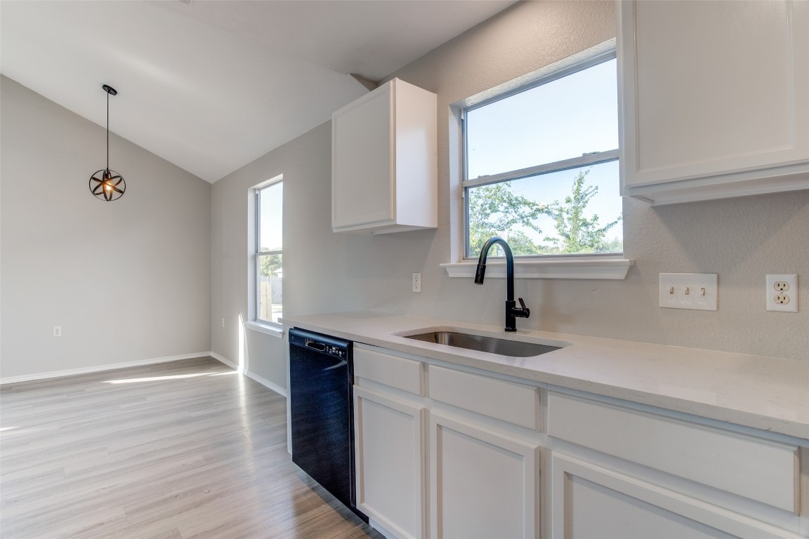 13145 Briarcreek Loop Manor, TX 78653 - Photo 14 of 25 a kitchen with a sink and cabinets