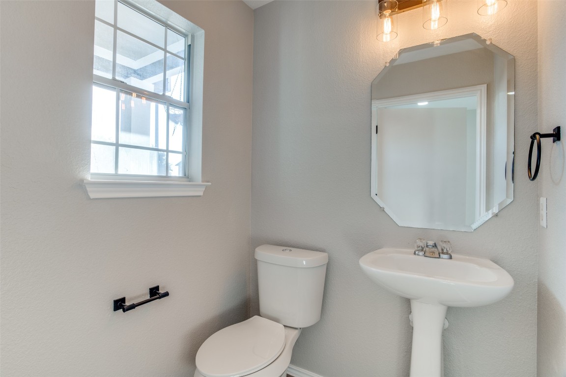 13145 Briarcreek Loop Manor, TX 78653 - Photo 16 of 25 a bathroom with a toilet sink and mirror