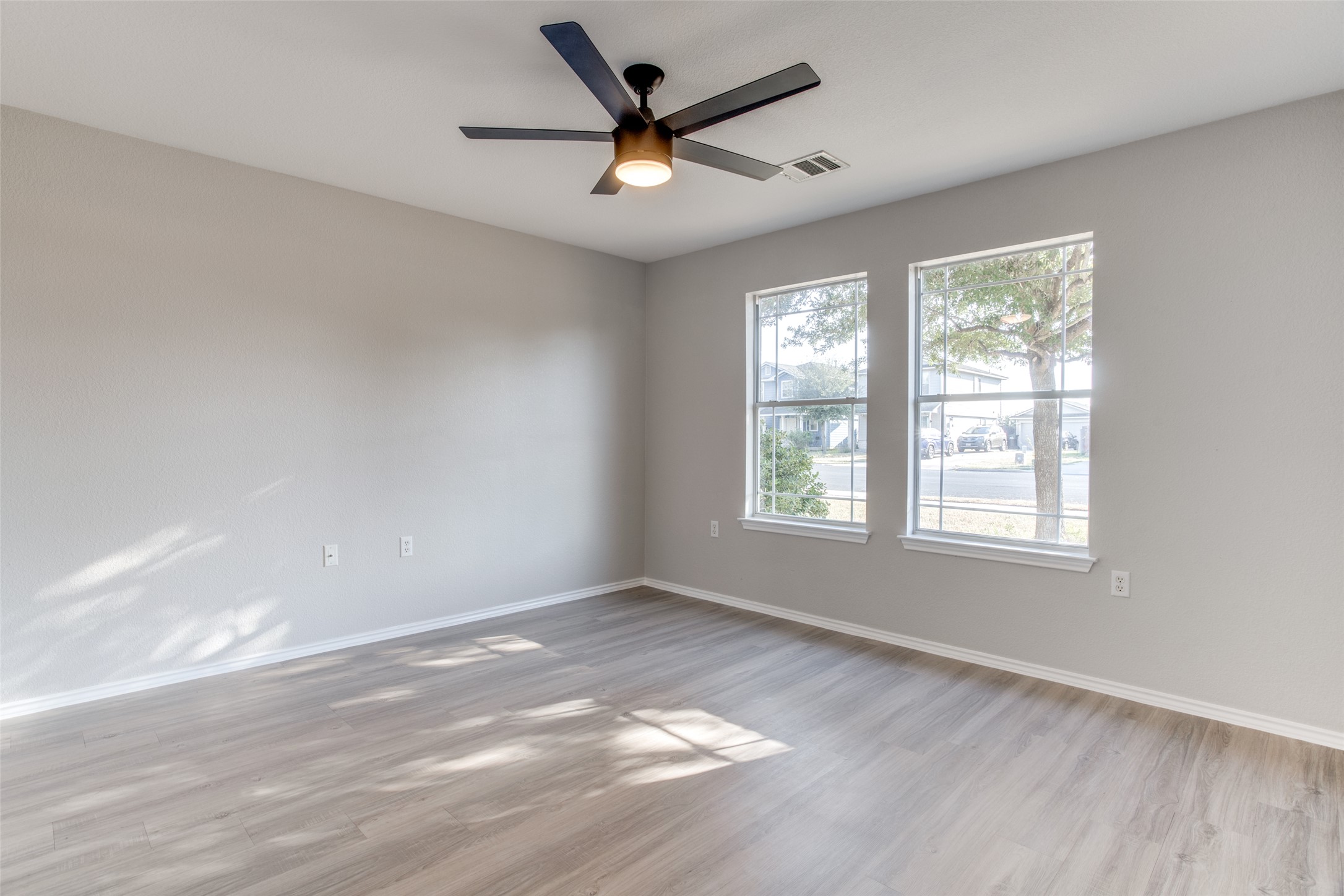 13145 Briarcreek Loop Manor, TX 78653 - Photo 17 of 25 a view of a livingroom with a window and wooden floor