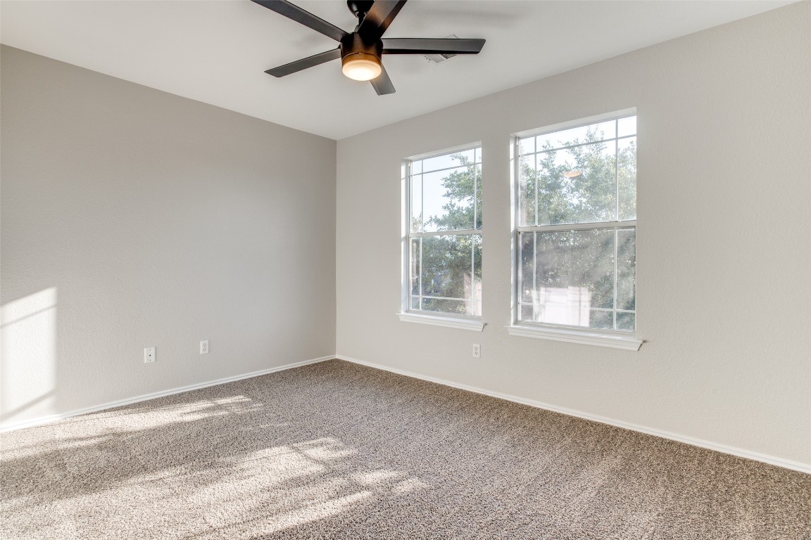 13145 Briarcreek Loop Manor, TX 78653 - Photo 20 of 25 an empty room with a window and a fan