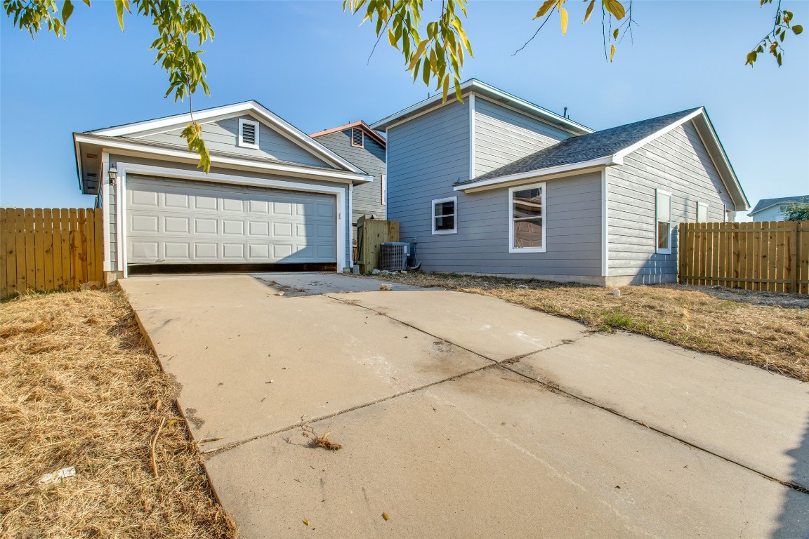 13145 Briarcreek Loop Manor, TX 78653 - Photo 25 of 25 a front view of a house with a yard and garage