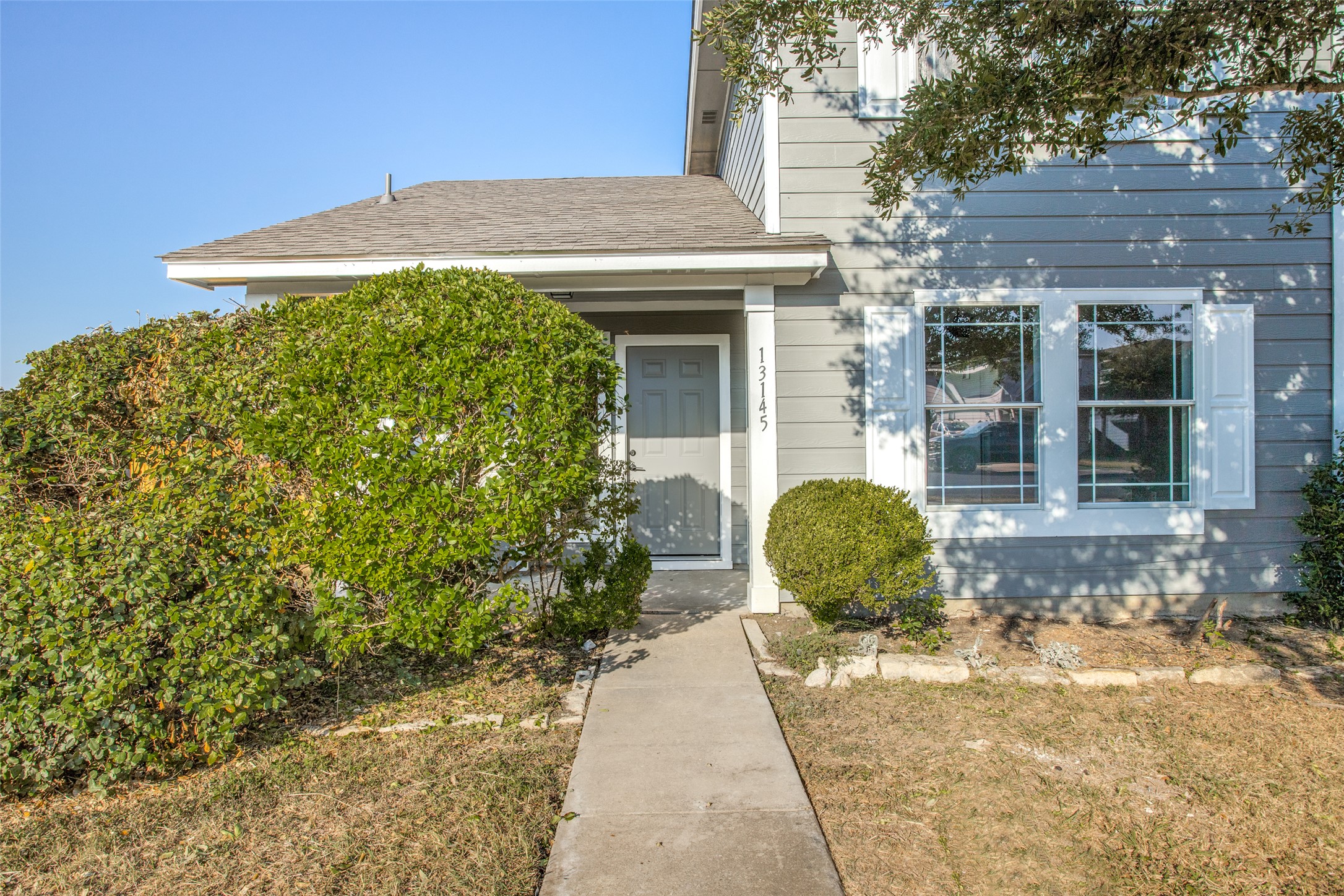 13145 Briarcreek Loop Manor, TX 78653 - Photo 3 of 25 a front view of a house with garden