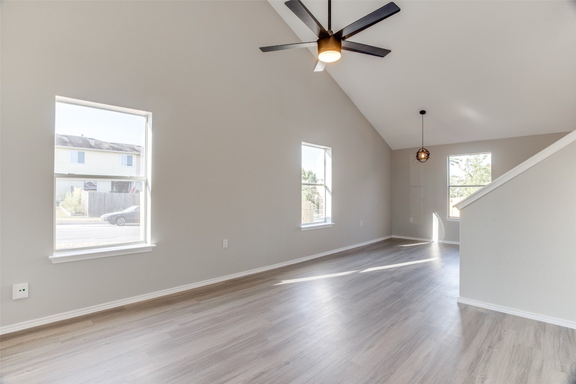 13145 Briarcreek Loop Manor, TX 78653 - Photo 6 of 25 a view of an empty room with a window and wooden floor