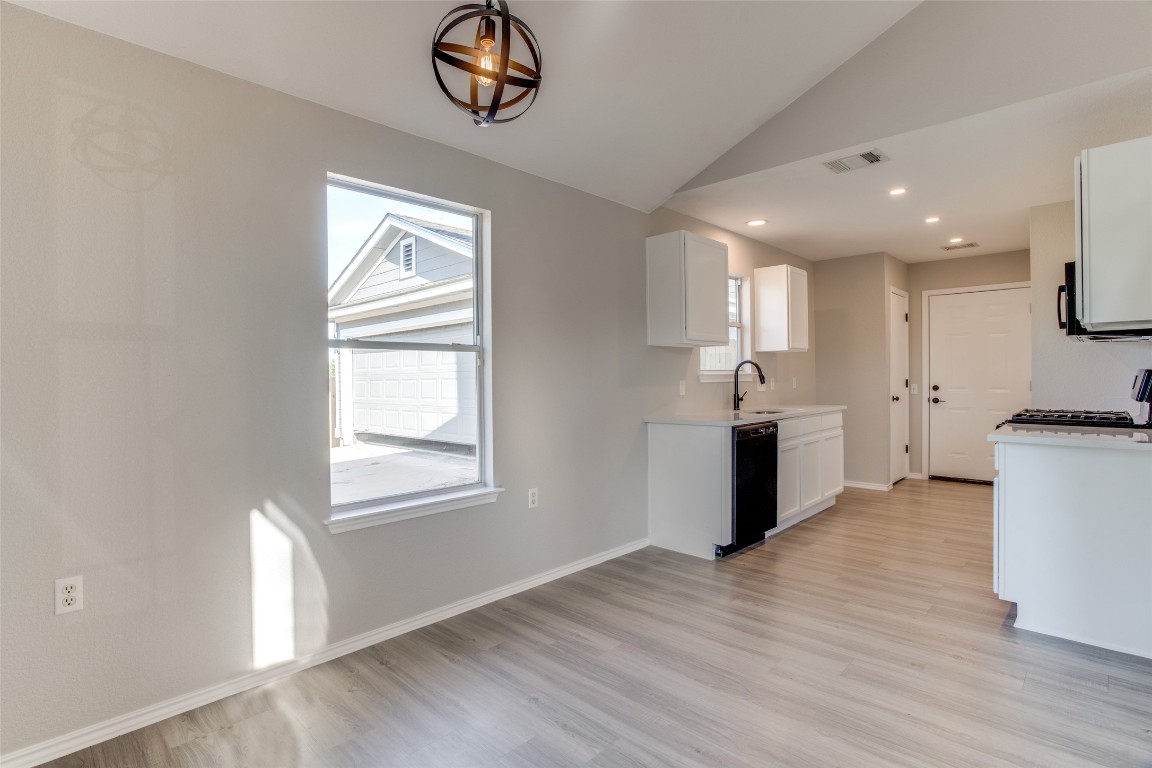 13145 Briarcreek Loop Manor, TX 78653 - Photo 9 of 25 a kitchen with a refrigerator and a stove top oven