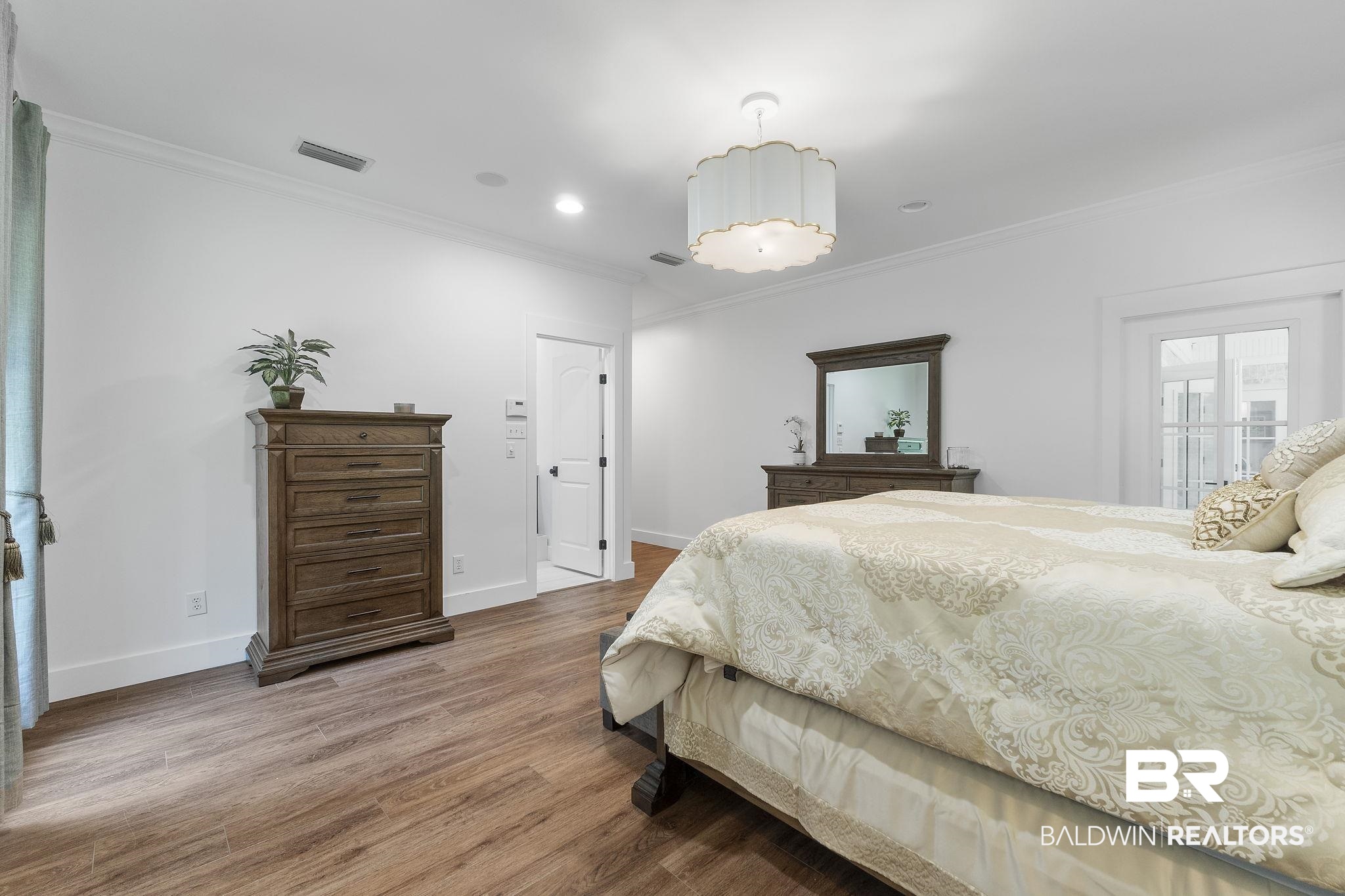 4451 Millhouse Road Gulf Shores, AL 36542 - Photo 27 of 50 Bedroom featuring crown molding and hardwood / wood-style floors