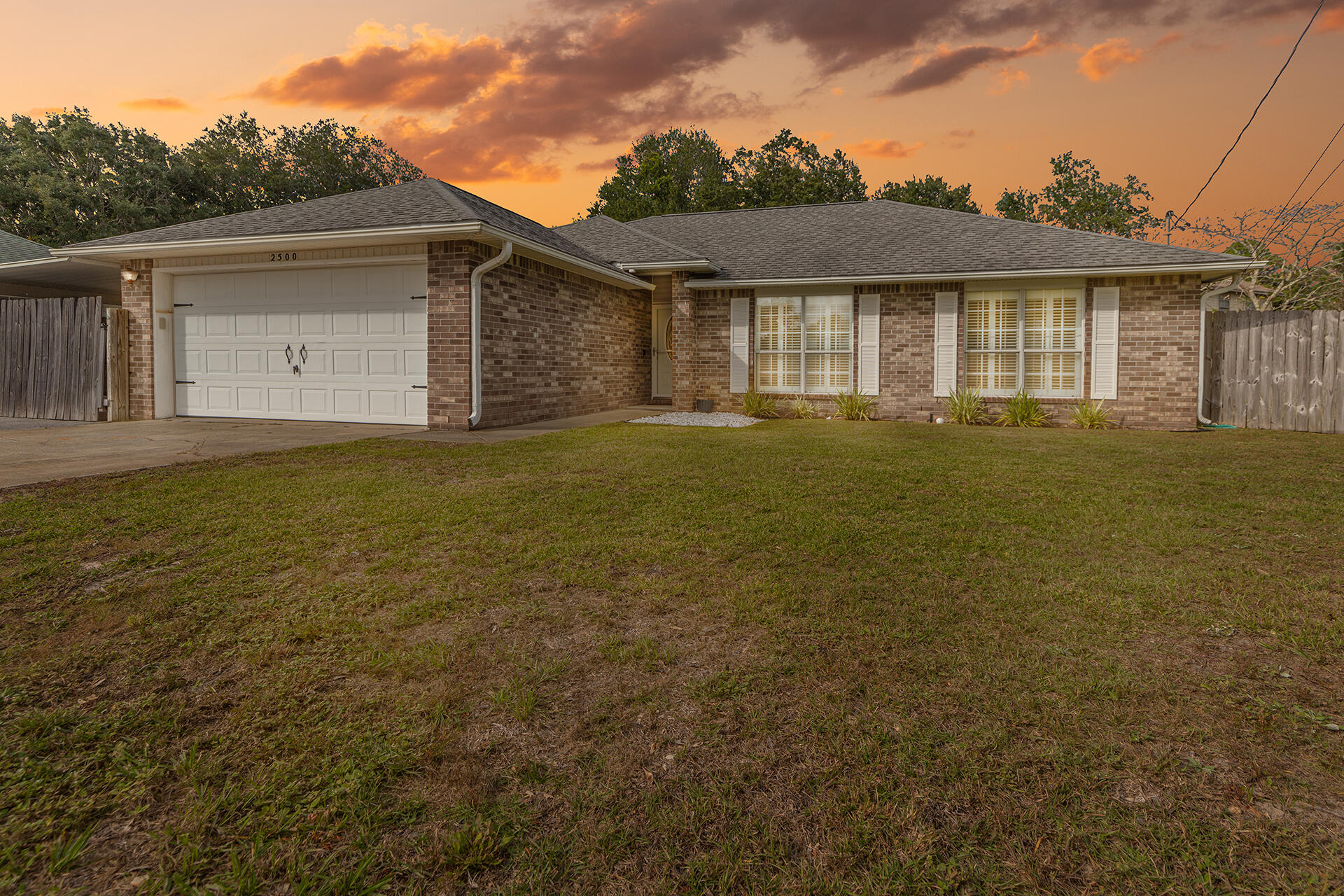 2500 Cameron Way Navarre, FL 32566 - Photo 2 of 32 a front view of a house with a garden