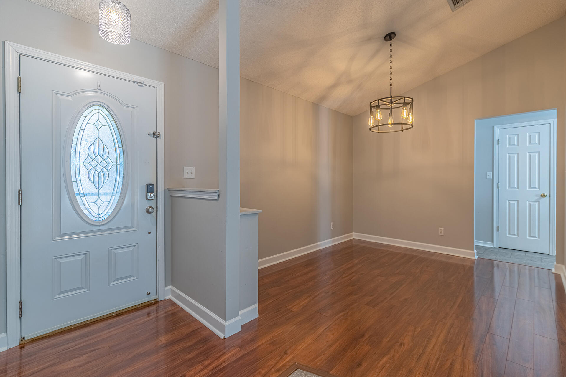 2500 Cameron Way Navarre, FL 32566 - Photo 11 of 32 an empty room with wooden floor and mirror