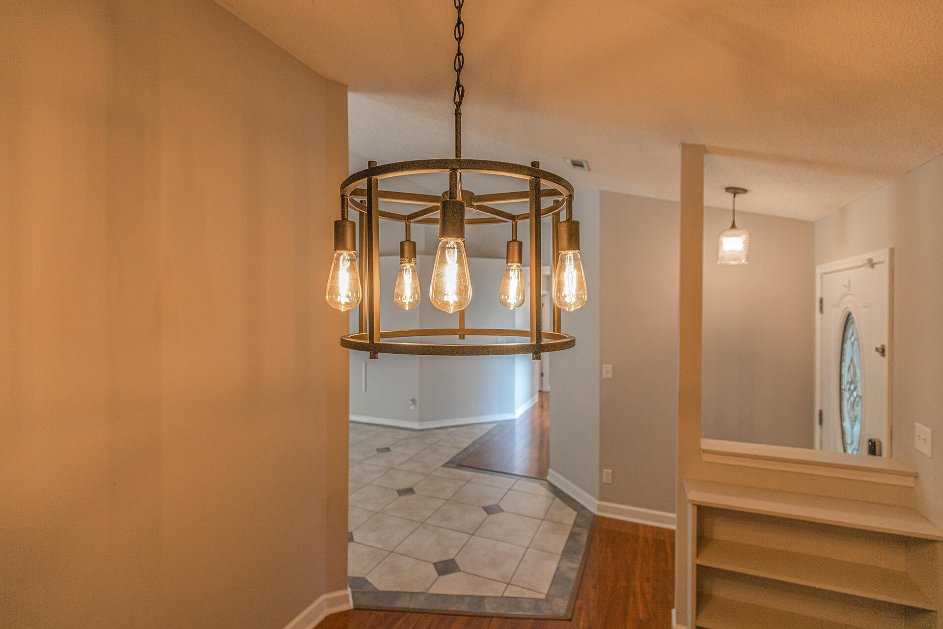 2500 Cameron Way Navarre, FL 32566 - Photo 13 of 32 a view of a hallway with wooden floor and a chandelier