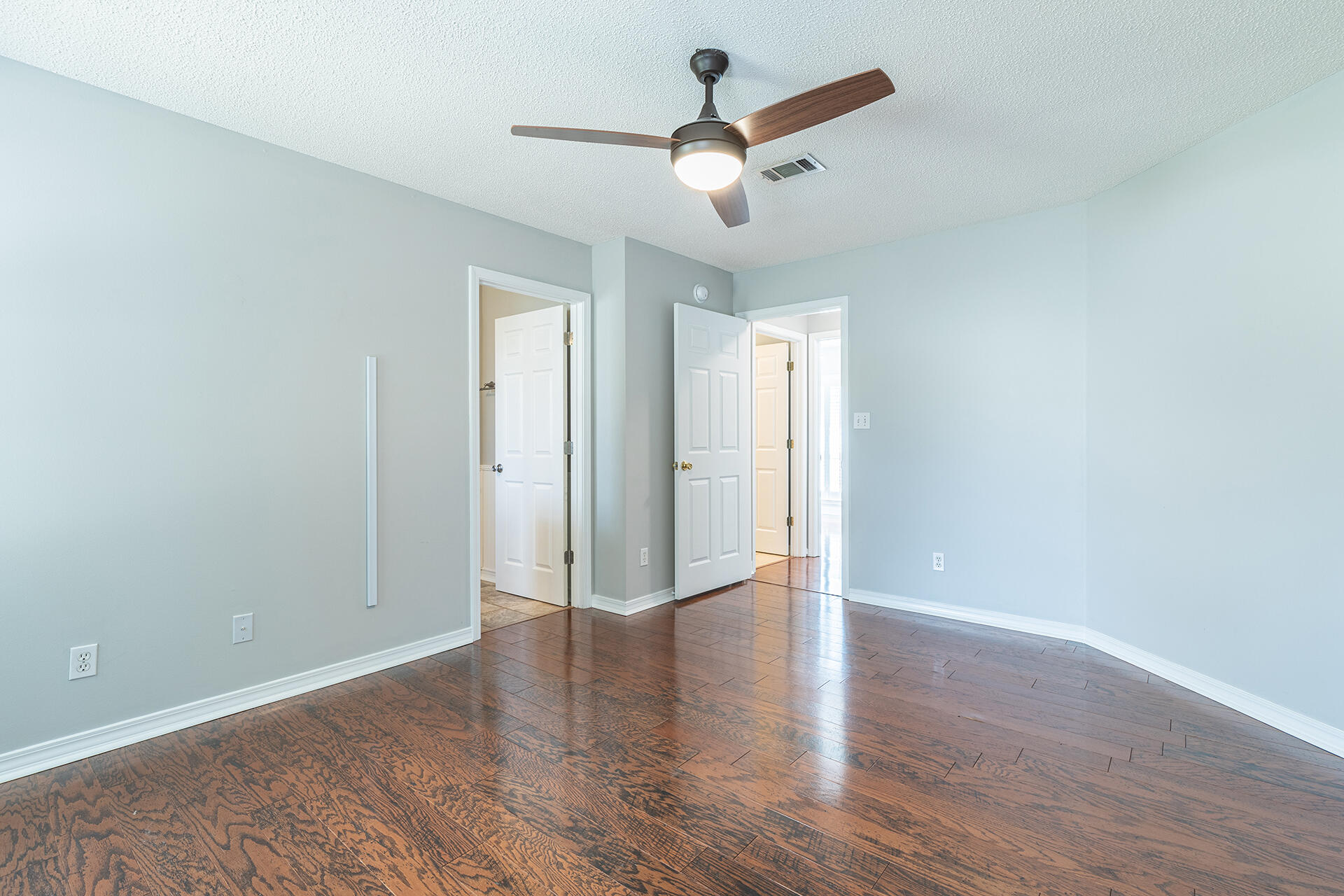 2500 Cameron Way Navarre, FL 32566 - Photo 17 of 32 an empty room with wooden floor and ceiling fan