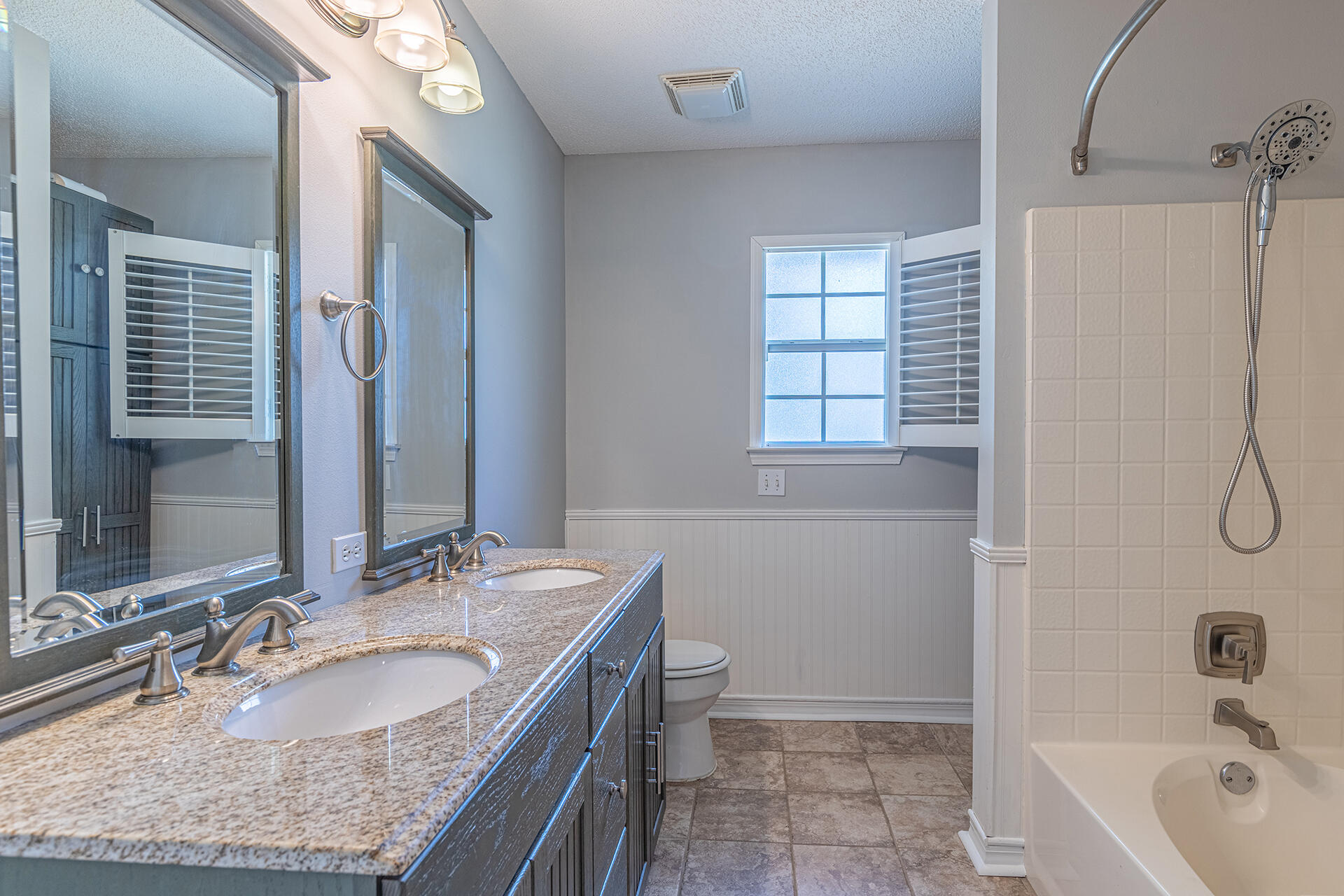 2500 Cameron Way Navarre, FL 32566 - Photo 18 of 32 a bathroom with a granite countertop sink a mirror a toilet and bathtub