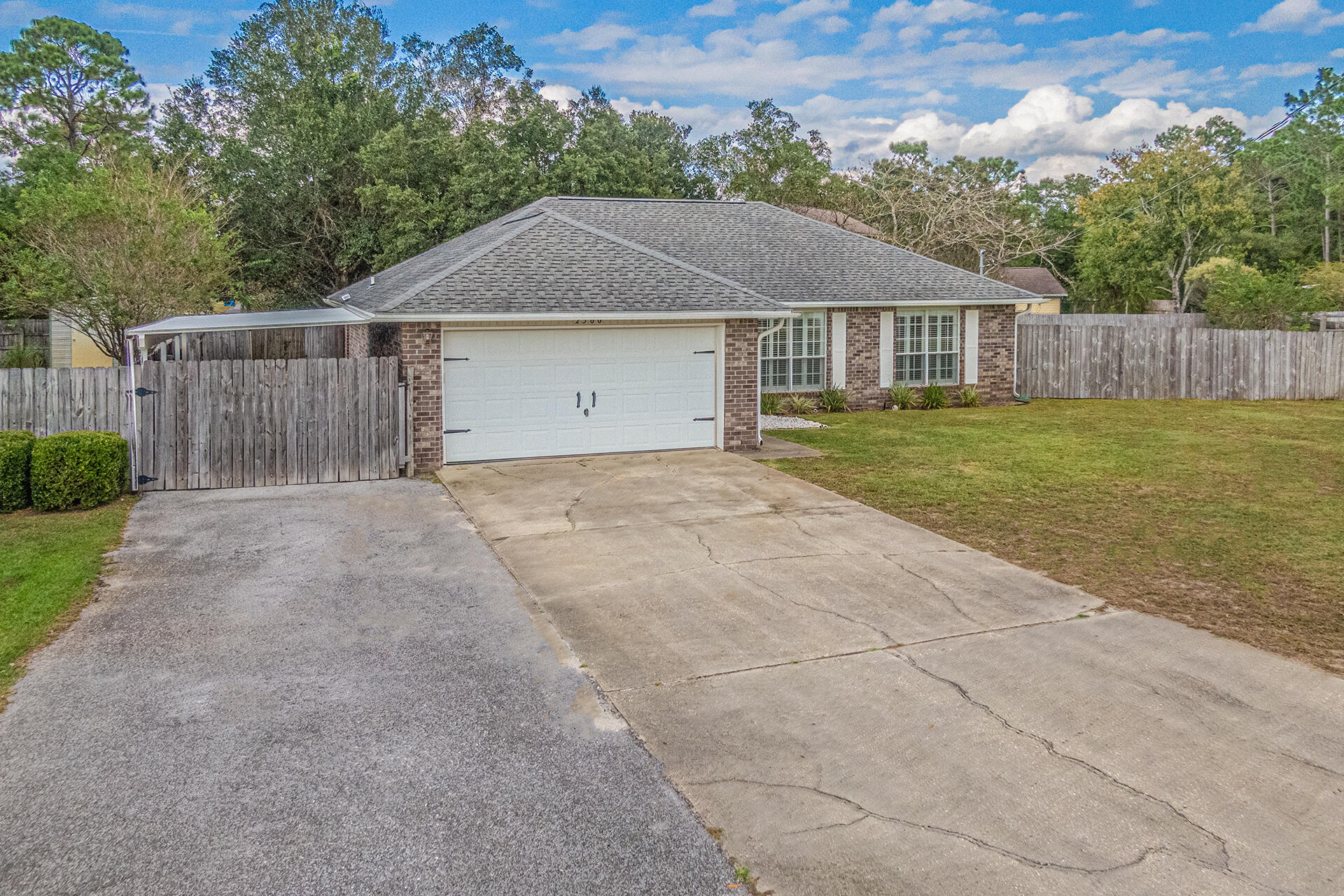 2500 Cameron Way Navarre, FL 32566 - Photo 3 of 32 a front view of a house with a yard and garage