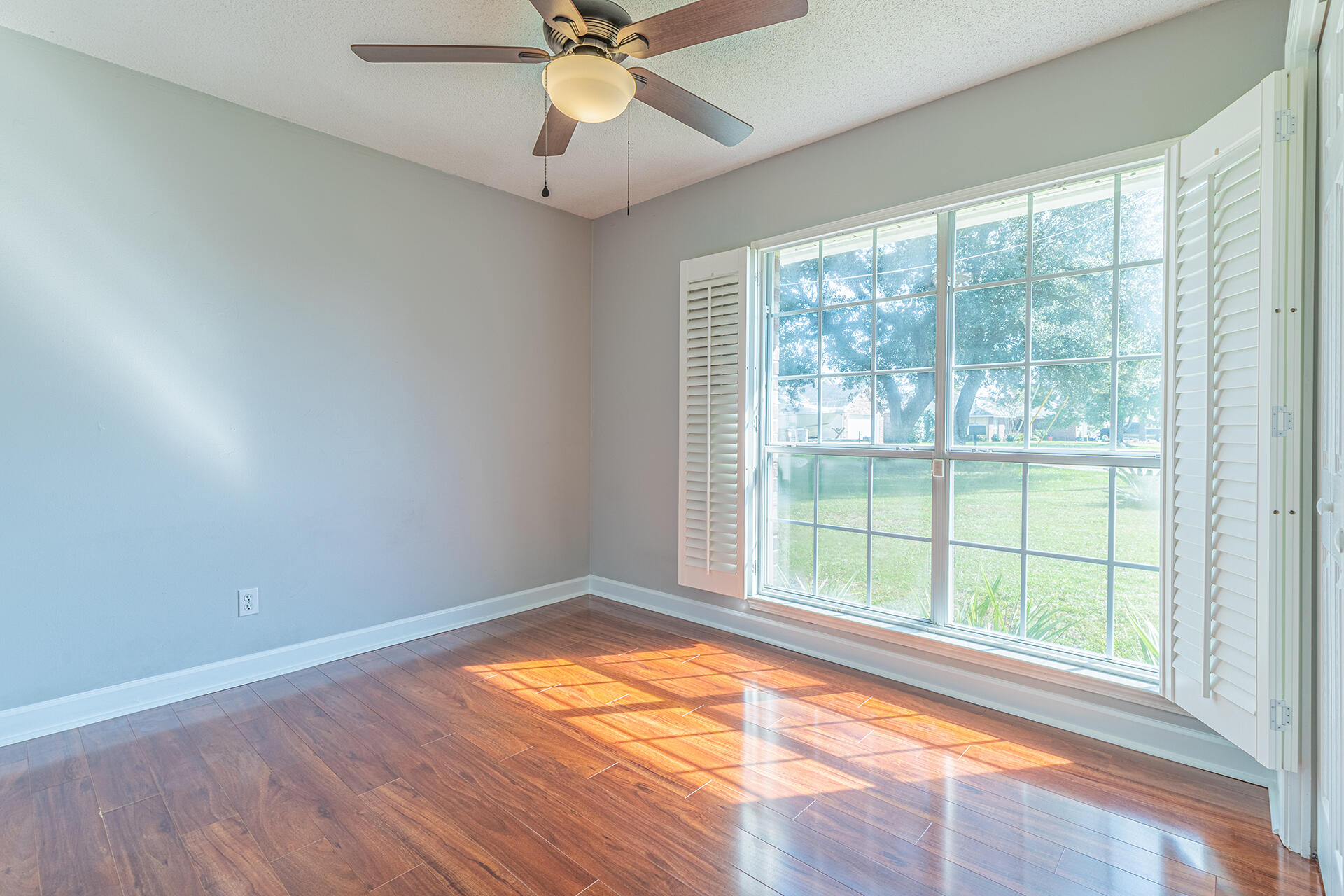 2500 Cameron Way Navarre, FL 32566 - Photo 21 of 32 a view of an empty room with wooden floor and a window