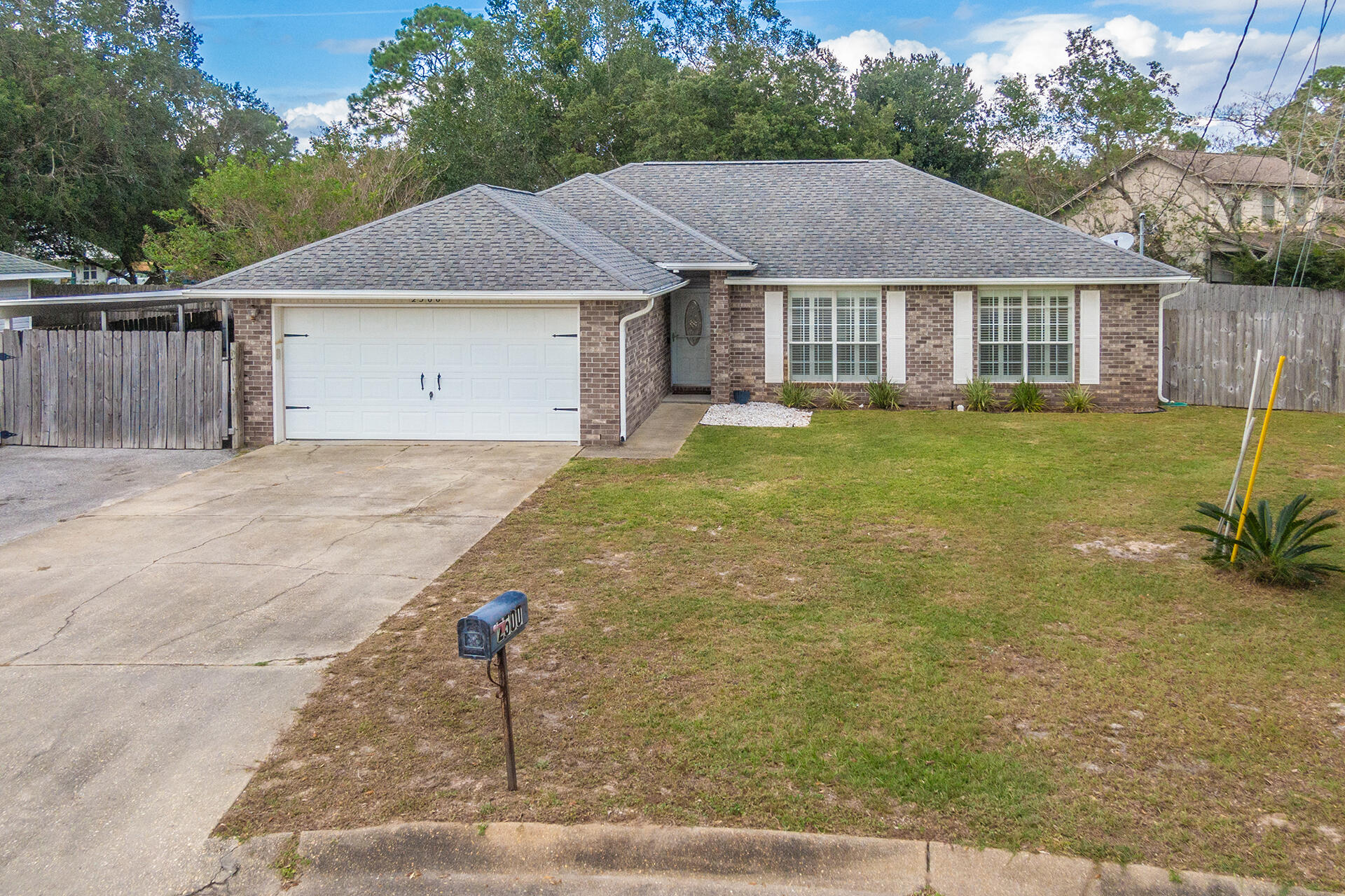 2500 Cameron Way Navarre, FL 32566 - Photo 28 of 32 a view of a house with a yard and a garage