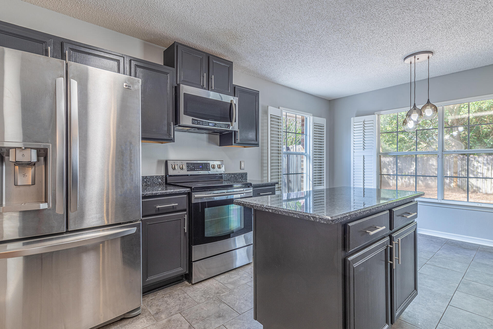 2500 Cameron Way Navarre, FL 32566 - Photo 4 of 32 a kitchen with stainless steel appliances granite countertop a refrigerator stove a sink and dishwasher