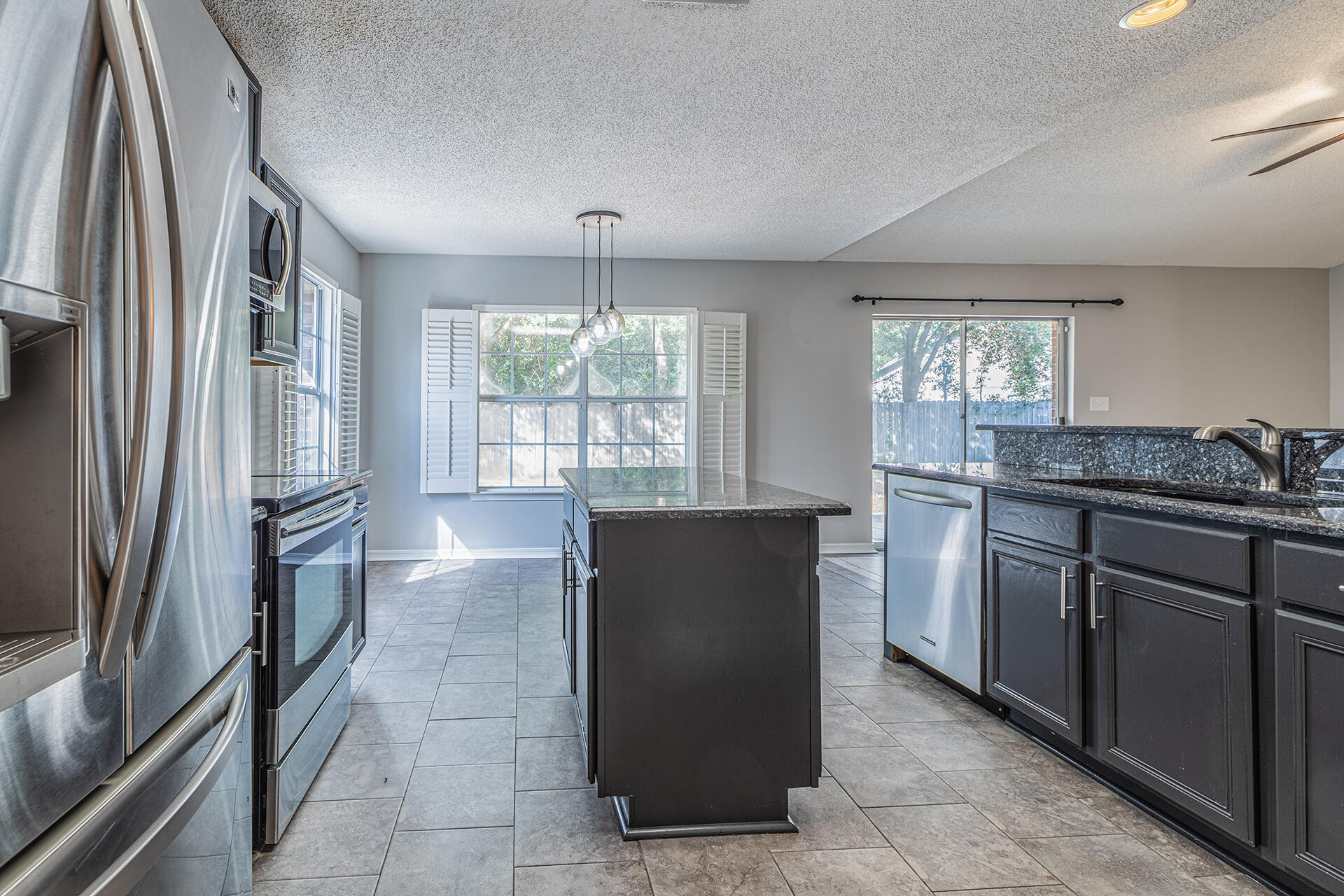 2500 Cameron Way Navarre, FL 32566 - Photo 7 of 32 a kitchen with granite countertop a refrigerator and a sink