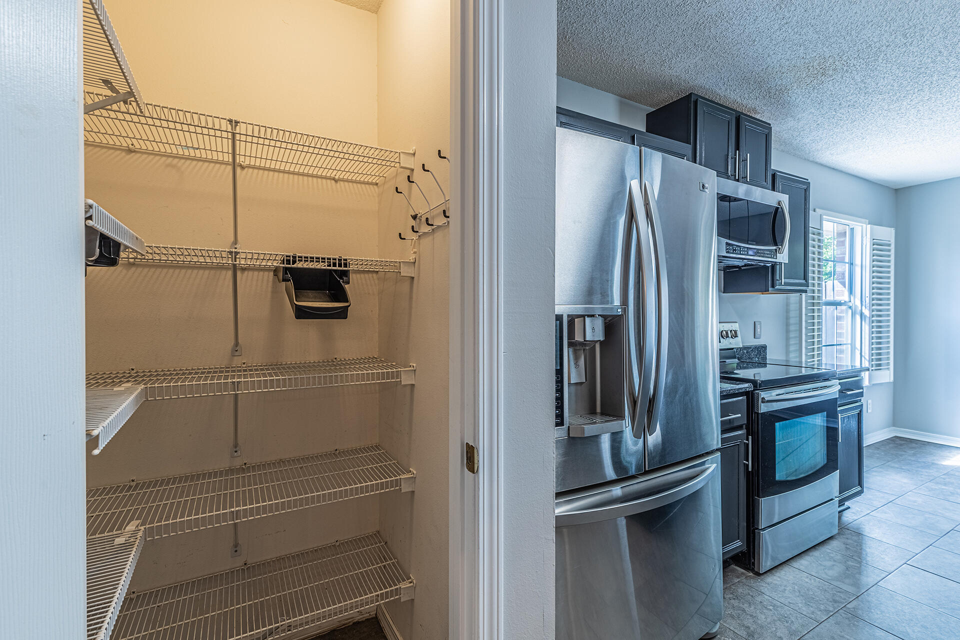 2500 Cameron Way Navarre, FL 32566 - Photo 8 of 32 a view of a refrigerator in kitchen and an empty room
