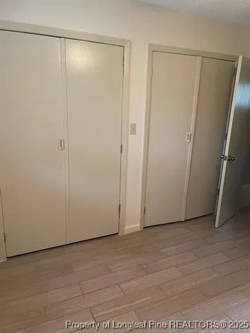 an empty room with a ceiling fan and window