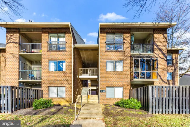 a view of a brick house with large windows