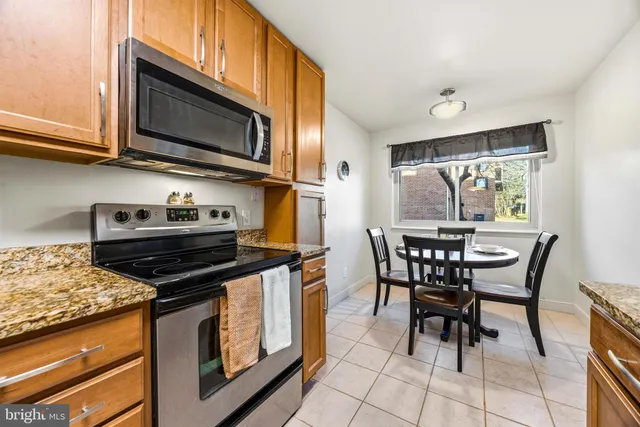 a kitchen with stainless steel appliances a stove a sink and a microwave