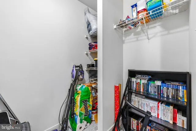 a view of that has couches and a book shelf