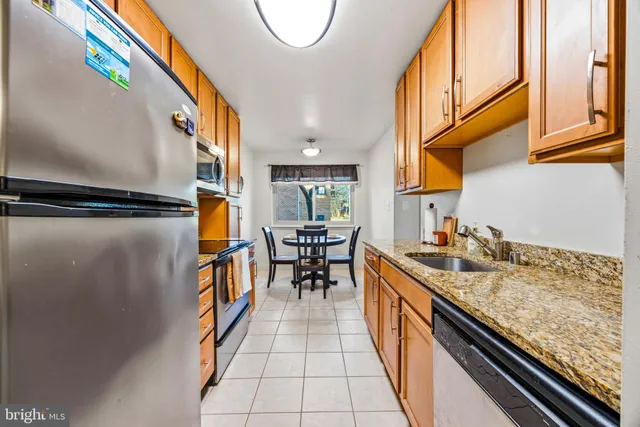 a kitchen with granite countertop lots of counter top space and wooden floor