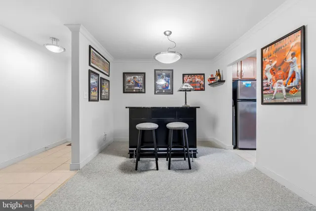 a living room with furniture and a wall painting