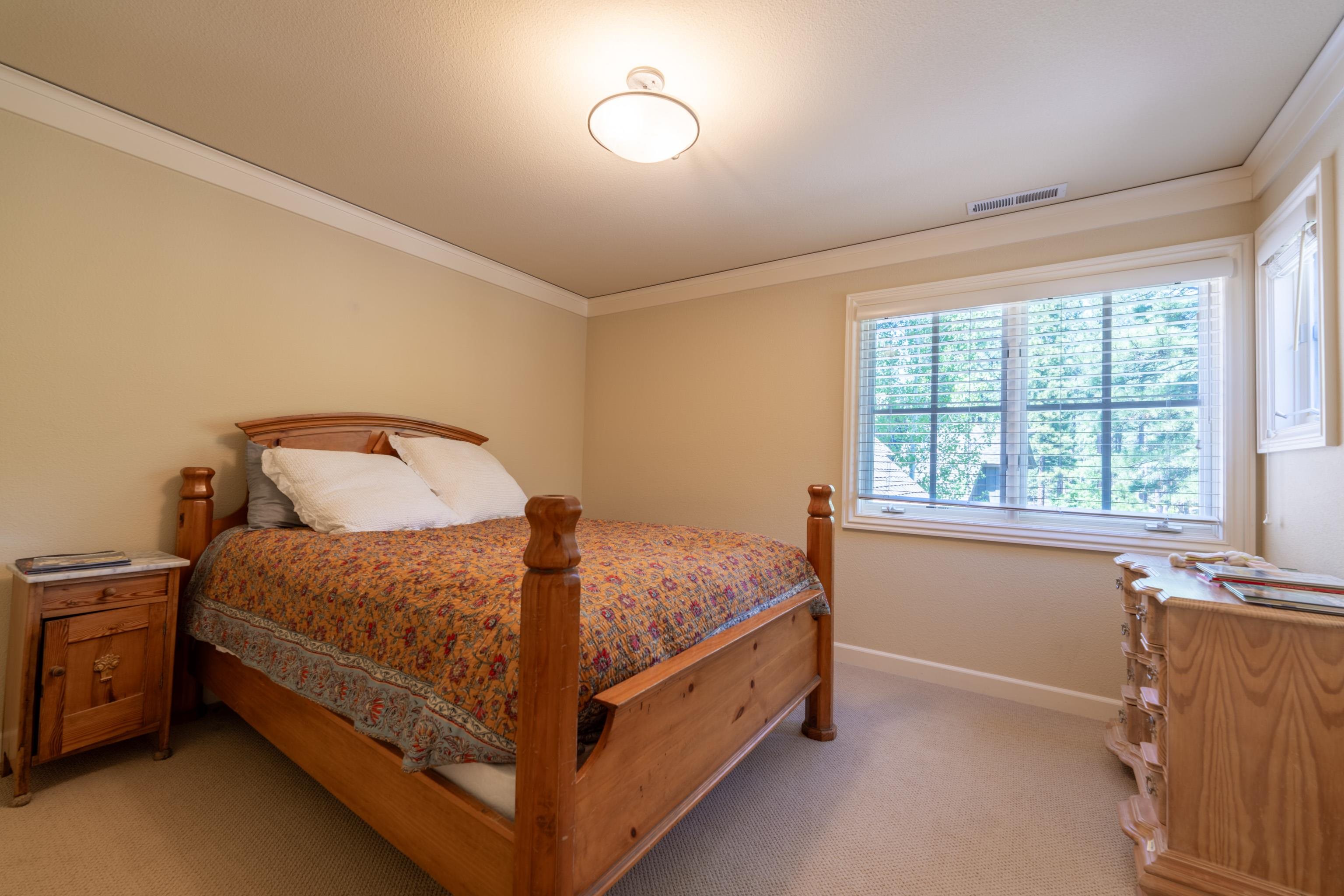 40 Hawk Ridge Clio, CA 96106 - Photo 23 of 42 a bed sitting in a bedroom next to a window