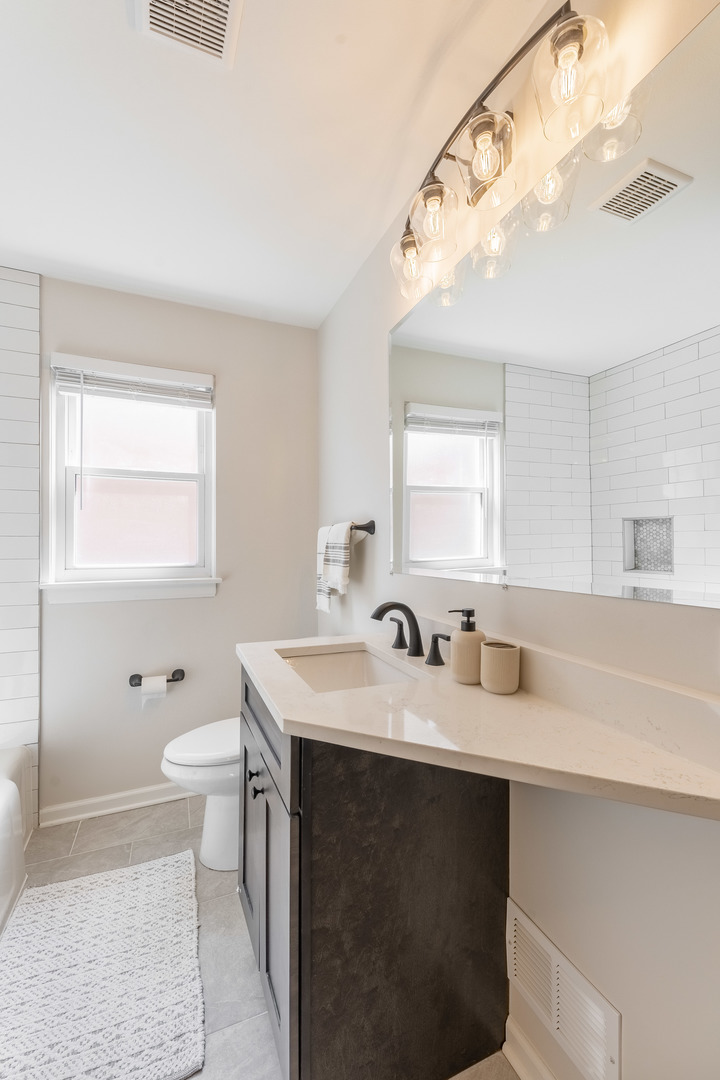 2335 14th Avenue North Riverside, IL 60546 - Photo 13 of 33 a bathroom with a sink and a mirror