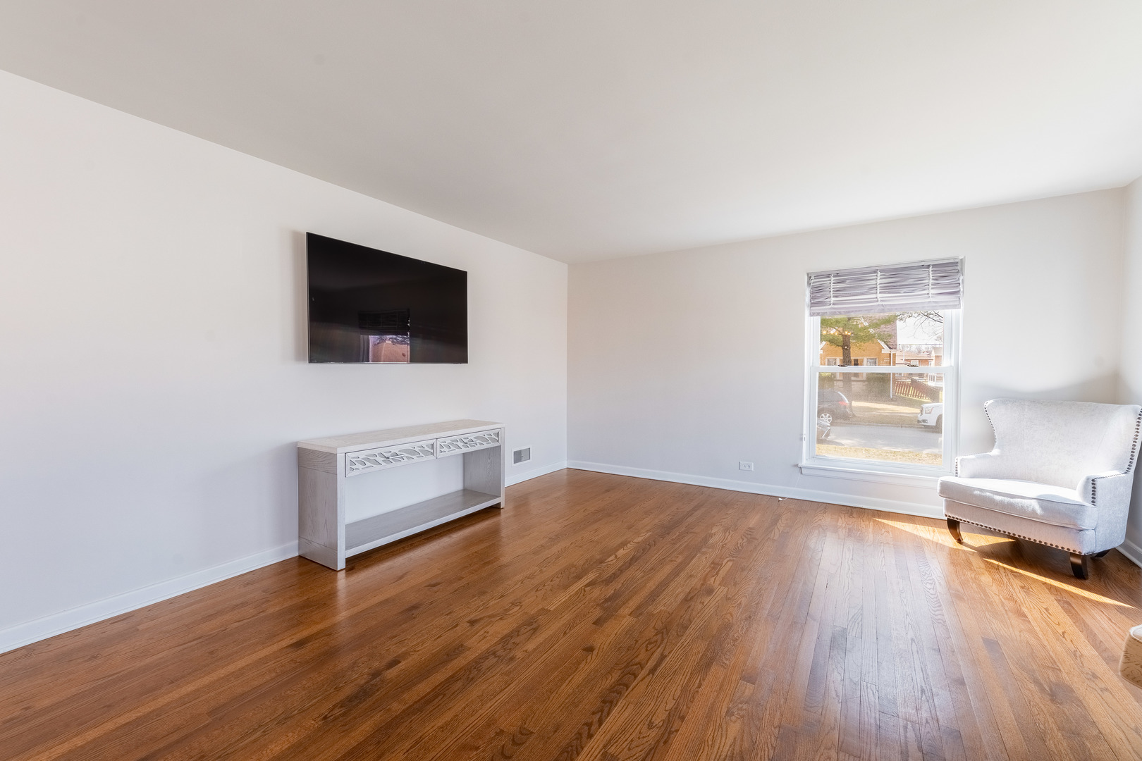 2335 14th Avenue North Riverside, IL 60546 - Photo 6 of 33 a living room with a flat screen tv a rug and a window