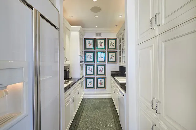 a living room with furniture and large windows