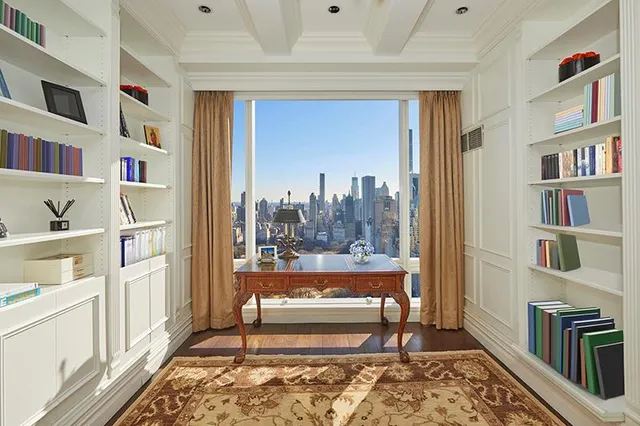 a living room with furniture cabinets and a rug