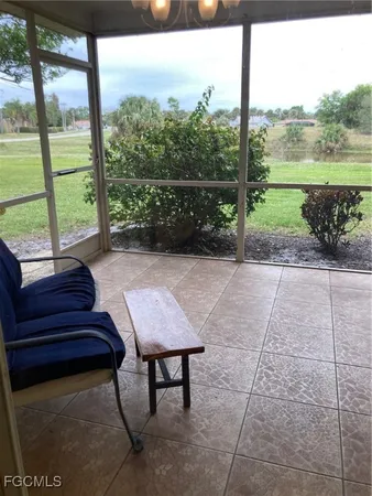 a view of a patio with a table chairs and a garden