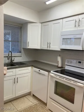 a kitchen with cabinets appliances and a sink