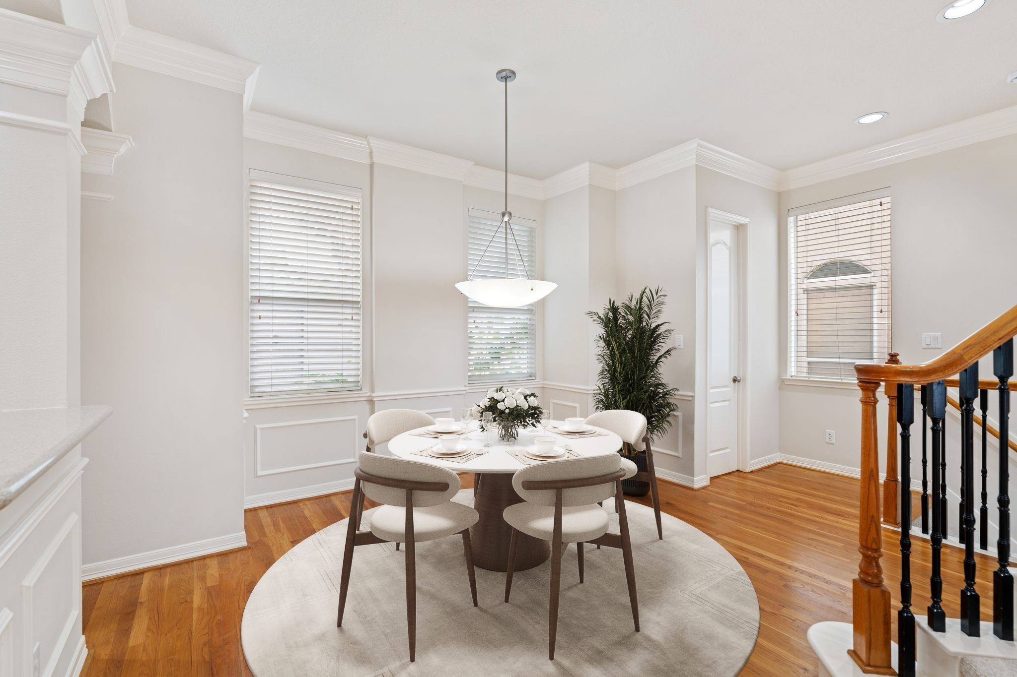 920 Asbury Street Houston, TX 77007 - Photo 11 of 33 a dining room with furniture a chandelier and wooden floor