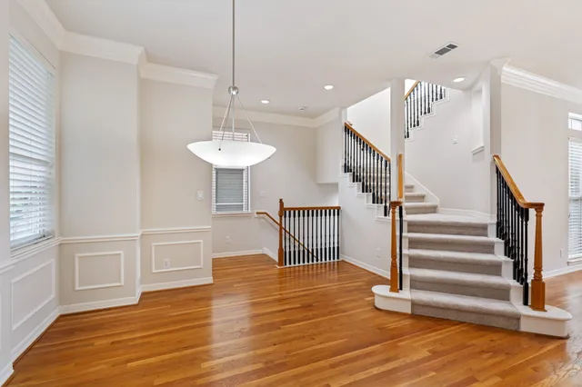 a view of a room with wooden floor and stairs