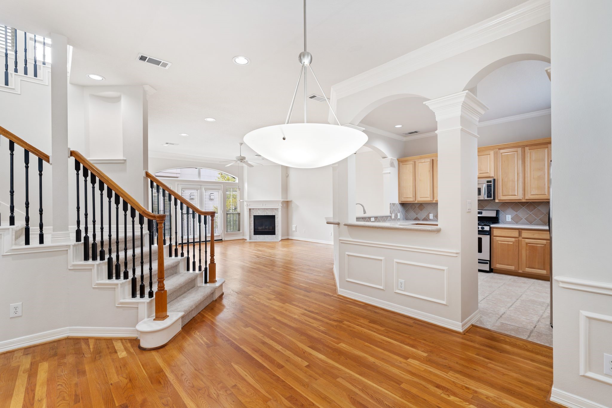 920 Asbury Street Houston, TX 77007 - Photo 14 of 33 a kitchen with stainless steel appliances kitchen island granite countertop a stove a refrigerator and a sink