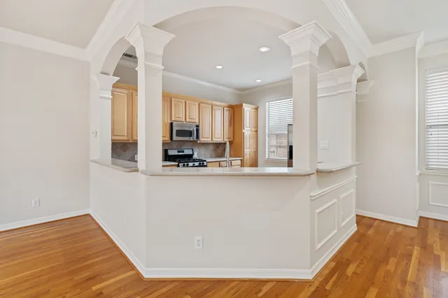 a kitchen with stainless steel appliances a refrigerator and a stove top oven