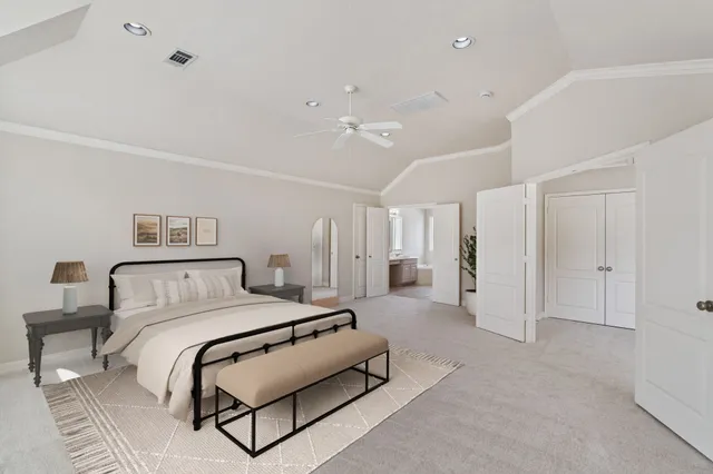 a spacious bedroom with a bed a couch and a chandelier