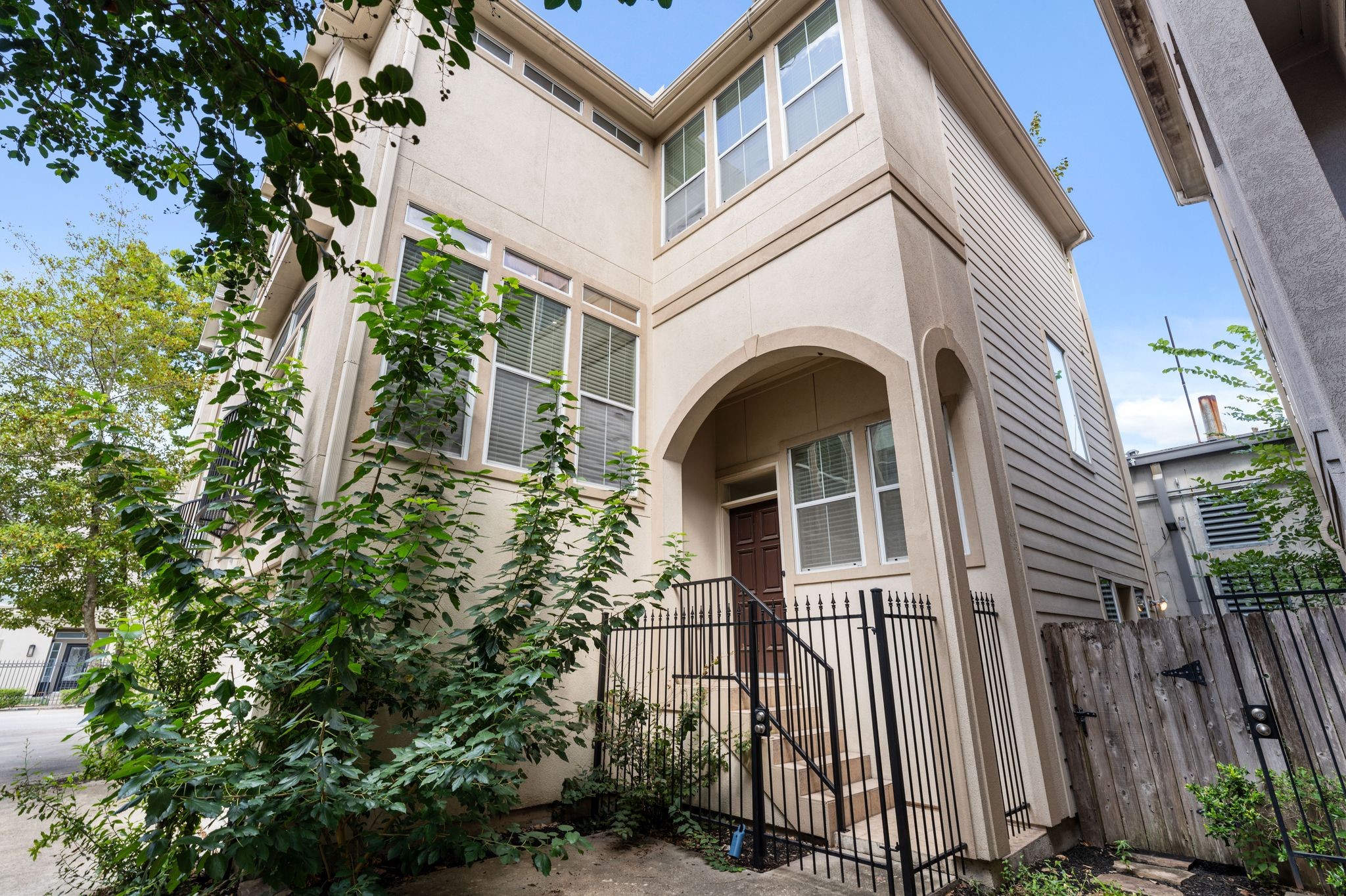 920 Asbury Street Houston, TX 77007 - Photo 33 of 33 a view of a white house with large windows and plants