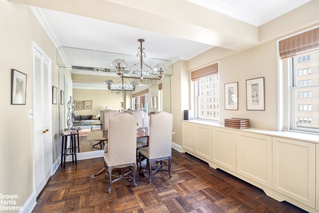 35 Park Avenue, Unit 12C Manhattan, NY 10016 - Photo 4 of 14 a dining room with furniture a chandelier and wooden floor